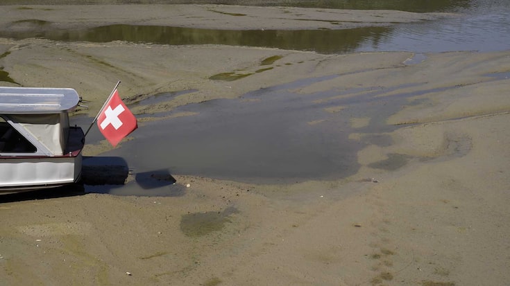 epa10077990 A Navigation Boat on the Lake of Brenets (French: Navigation sur le lac des Brenets) is trapped in the mud on the dried-out shore of the Brenet Lake (French: Lac des Brenets), part of the Doubs river, a natural border between eastern France and western Switzerland, 18 July 2022. The Swiss federal government increased the heat danger level to Level 3 out of 4 for almost all of Switzerland as authorities expect temperatures to rise up to 37 degrees Celsius in the coming days.  EPA/ANTHONY ANEX