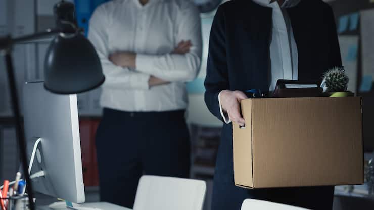 Licenciement immédiat: Une employée quitte son bureau sous le regard sévère de son chef