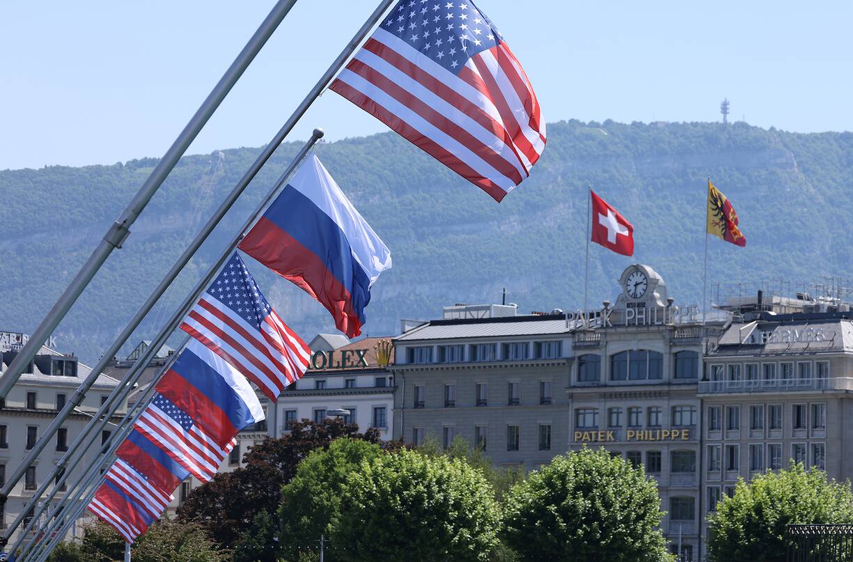 GENEVA, SWITZERLAND - JUNE 15: A Swiss flag flies behind Russian and American flags in the city center prior to a meeting between U.S. President Joe Biden and Russian President Vladimir Putin on June 15, 2021 in Geneva, Switzerland. Biden and Putin are to meet in Geneva for a one-day summit at the nearby Villa La Grange tomorrow. (Photo by Sean Gallup/Getty Images)