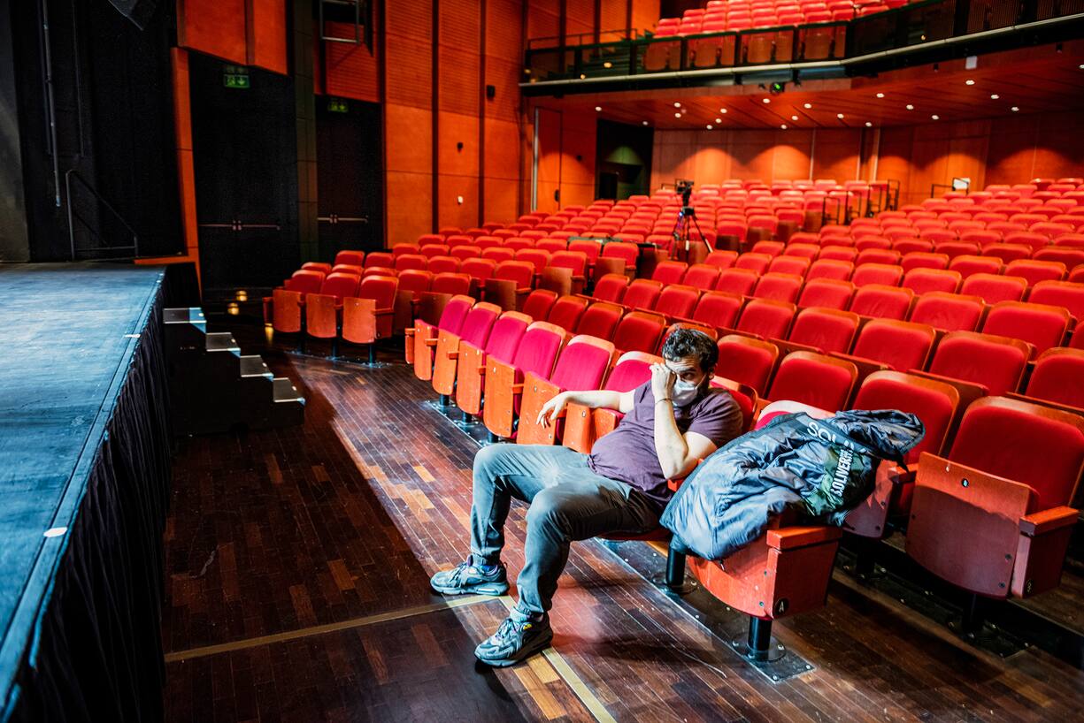 Adrien Laplana, member of Alliance Creative at the end of an experimental performance using improvised music, acting drawing, without an audience, at Théâtre Forum Meyrin. Théâtre Forum Meyrin was forced to cancel it's whole season, and decided to offer it's stage and technicians to artists wishing to experiment on it's grand stage, each spread over a different week. Photography by Mark Henley/Flux Foundation from series 'Culture Phantom'.