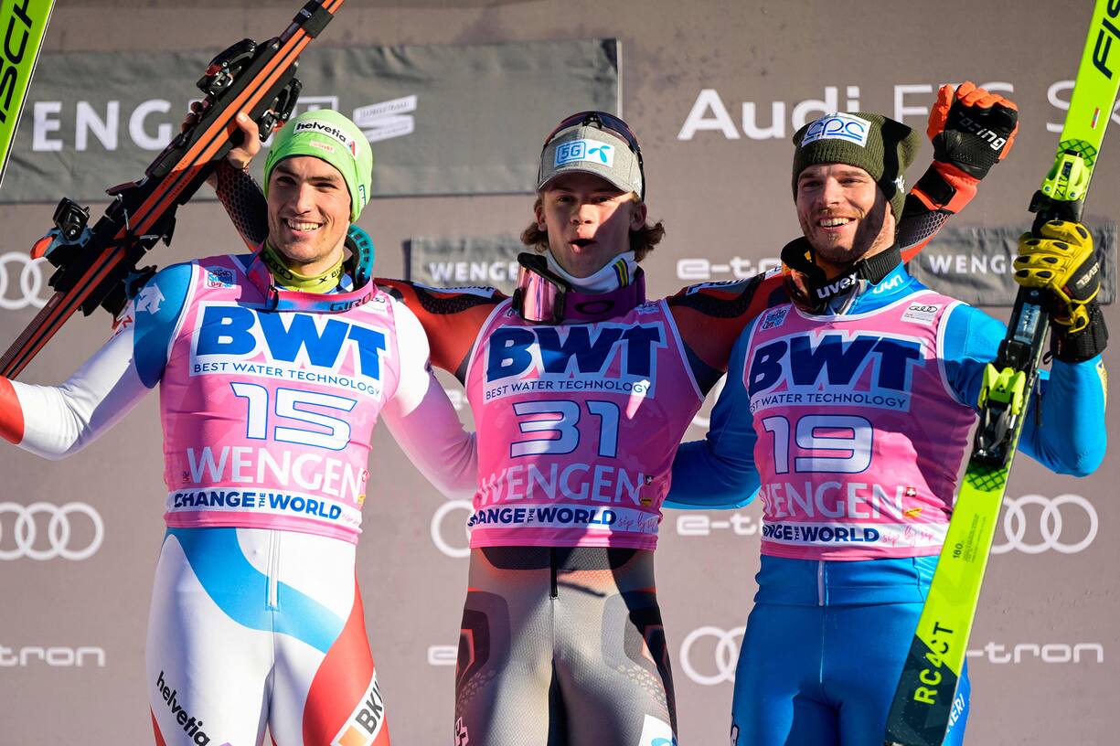 Switzerland's Daniel Yule (L), 2nd place, Norway's Lucas Braathen (C), 1st place, and Italy's Giuliano Razzoli (R), 3rd place, celebrate on the podium after the men's FIS Ski World Cup Slalom in Wengen, Switzerland, on January 16, 2022. (Photo by Fabrice COFFRINI / AFP)