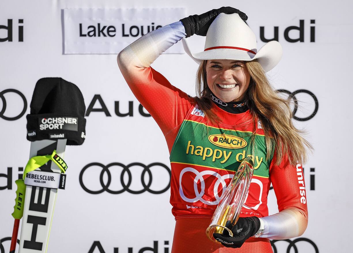Switzerland's Corinne Suter celebrates her victory on the podium following the women's World Cup super-G ski race in Lake Louise, Alberta, on Sunday Dec. 4, 2022. (/Jeff McIntosh/The Canadian Press via AP)