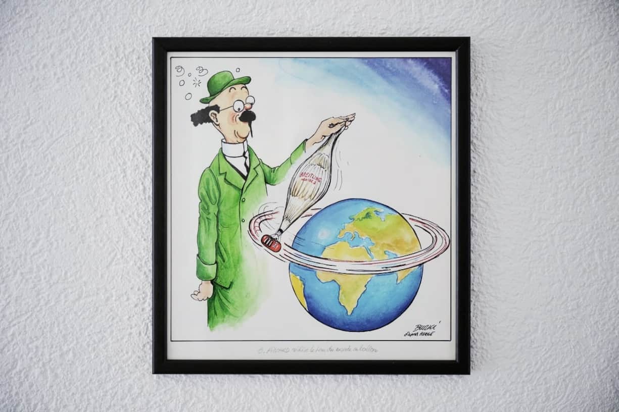 Le dessin de presse de Raymond Burki rappelant qu’Auguste Piccard avait inspiré le professeur Tournesol à Hergé est tapissé sur un mur de la Fondation Solar Impulse