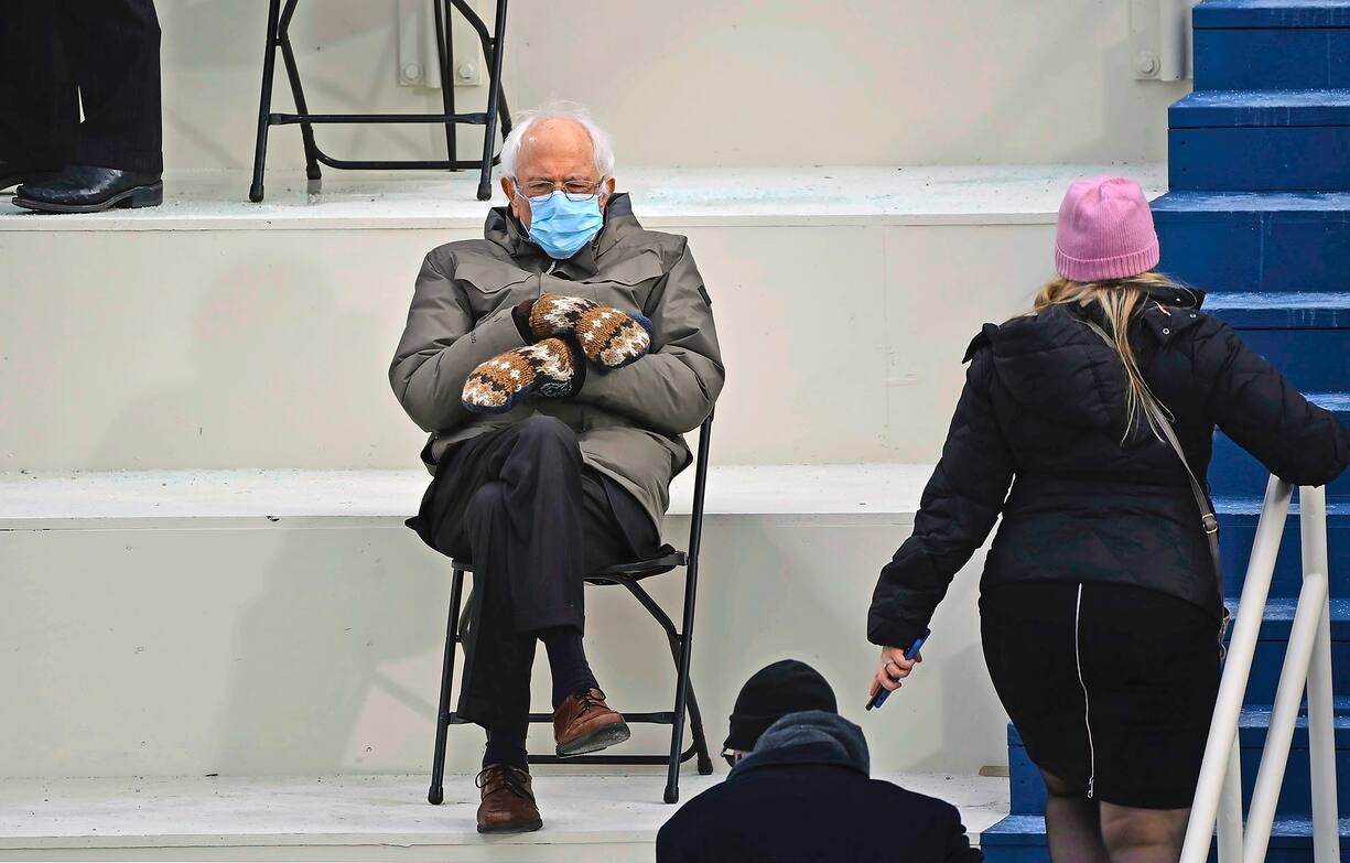 TOPSHOT - Former presidential candidate, Senator Bernie Sanders (D-Vermont) sits in the bleachers on Capitol Hill before Joe Biden is sworn in as the 46th US President on January 20, 2021, at the US Capitol in Washington, DC. (Photo by Brendan SMIALOWSKI / AFP)