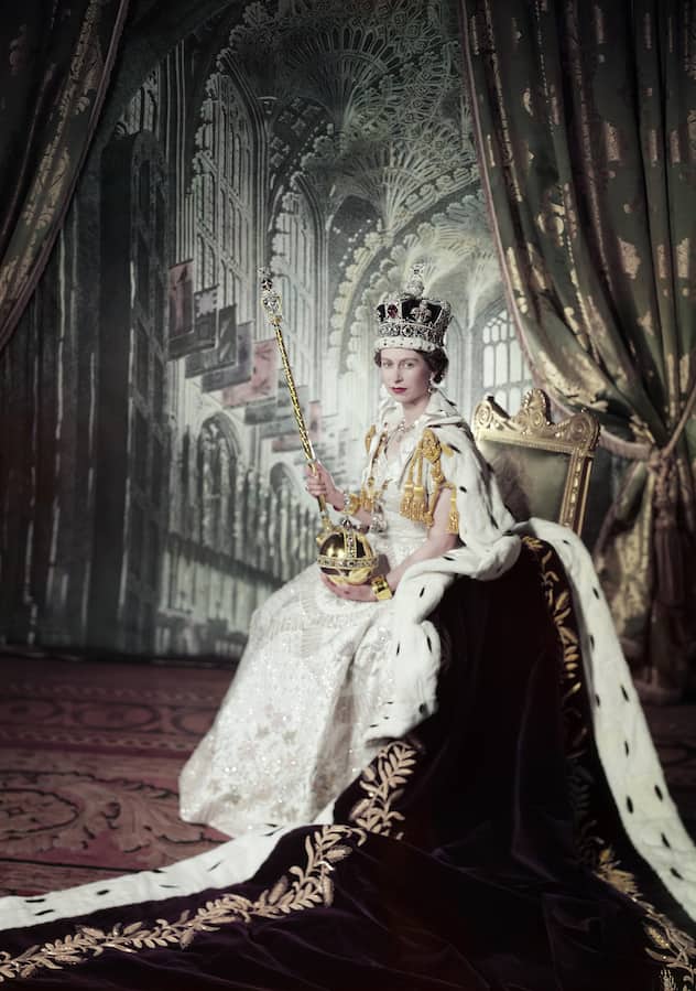 SPECIAL PRICE: Her Majesty Queen Elizabeth II in her coronation dress and Robe of Estate  holding the spectre and orb and and wearing the Imperial State Crown. This famous image by Cecil Beaton was taken on the occasion of  The Queen's  Coronation at Westminster Abbey on 2 June 1953 . The dress, created in the finest white duchesse satin, was designed by the British couturier Sir Norman Hartnell. Her Majesty?s Robe of Estate of purple silk velvet was made by the royal robe-makers Ede and Ravenscroft.