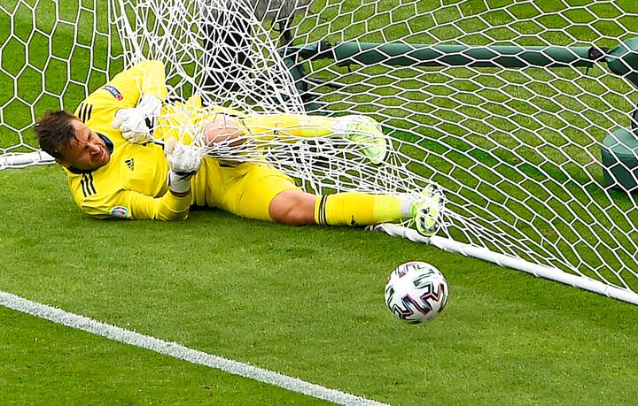 Scotland's goalkeeper David Marshall is caught in the goal's net after he failed to safe a long distance shot by Czech Republic's Patrik Schick during the Euro 2020 soccer championship group D match between Scotland and Czech Republic at Hampden Park stadium in Glasgow, Monday, June 14, 2021. (AP Photo/Andy Buchanan, Pool)