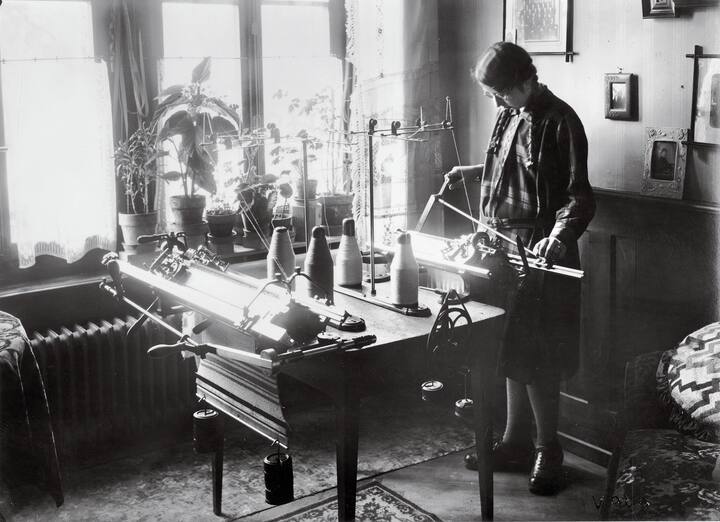 Femme manipulant une machine à tricoter