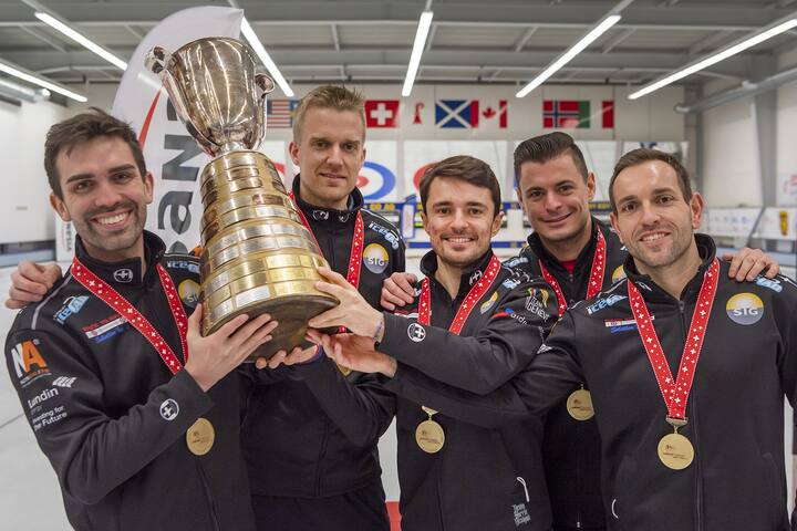 Das Sieger-Team Genf mit Skip Peter de Cruz, Coach Havard Vad Petersson, Benoit Schwarz, Valentin Tanner und Sven Michel, von links, posiert mit dem Pokal an der Siegerehrung der Curling Schweizermeisterschaft in Arlesheim, am Samstag, 13. Februar 2021. (KEYSTONE/Georgios Kefalas)