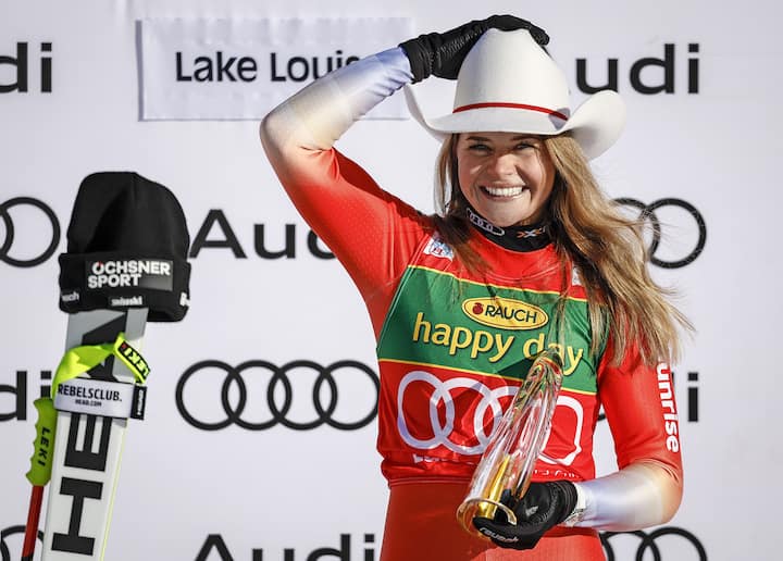 Switzerland's Corinne Suter celebrates her victory on the podium following the women's World Cup super-G ski race in Lake Louise, Alberta, on Sunday Dec. 4, 2022. (/Jeff McIntosh/The Canadian Press via AP)