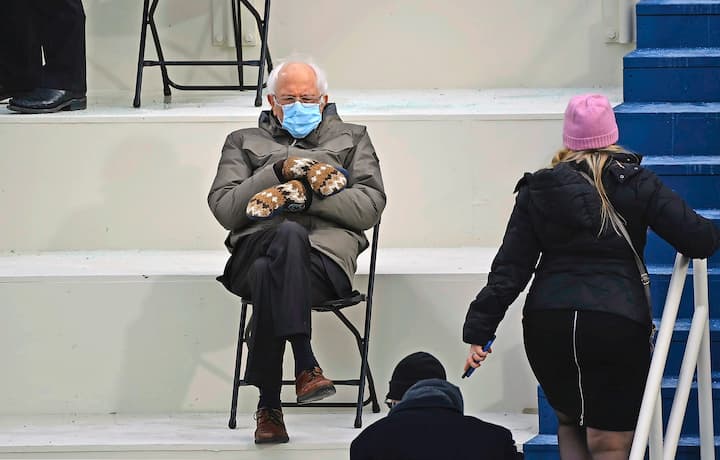 TOPSHOT - Former presidential candidate, Senator Bernie Sanders (D-Vermont) sits in the bleachers on Capitol Hill before Joe Biden is sworn in as the 46th US President on January 20, 2021, at the US Capitol in Washington, DC. (Photo by Brendan SMIALOWSKI / AFP)